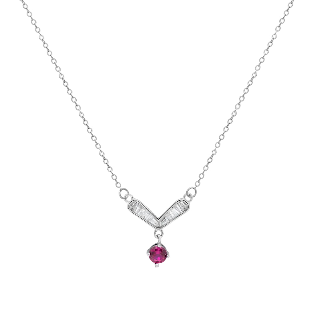Silver necklace with a V-shaped pendant and red gemstone on a white background