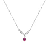 Silver necklace with a V-shaped pendant and red gemstone on a white background