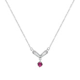 Silver necklace with a V-shaped pendant and red gemstone on a white background
