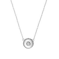 Silver necklace with a round pendant on a white background
