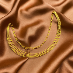 Gold chain necklace on brown satin fabric