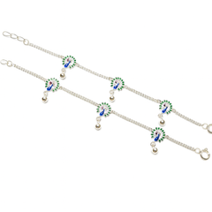 Silver anklet with green and blue peacock designs on a white background