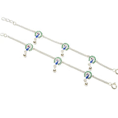 Silver anklet with green and blue peacock designs on a white background
