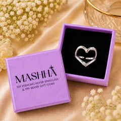 Silver heart-shaped ring in a purple MASHHA jewelry box with flowers around.