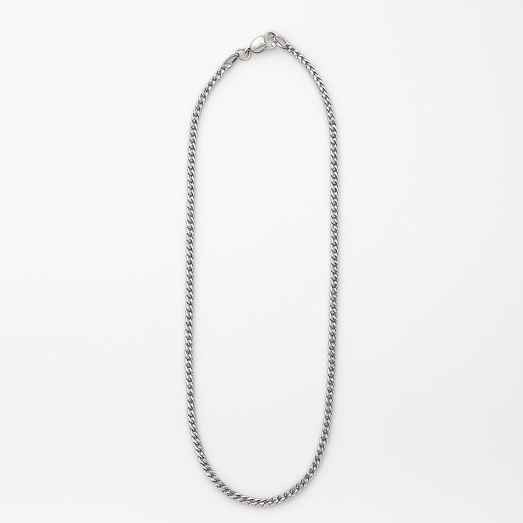 Silver chain necklace on a light gray background