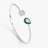 Silver bracelet with green gemstone on a white background