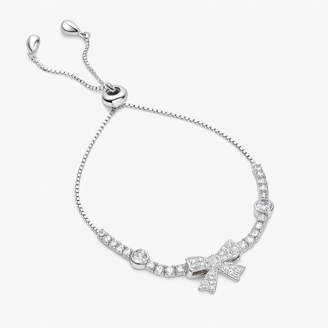 Silver bracelet with bow charm on a white background