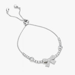 Silver bracelet with bow charm on a white background