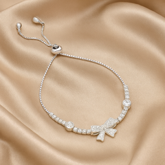 Silver Bow Charm Bracelet with Ruby Accents