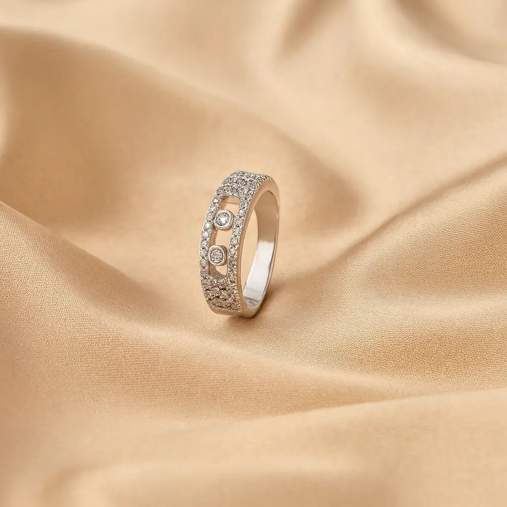 Silver ring with gemstones on a beige fabric background