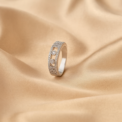 Silver ring with gemstones on a beige fabric background