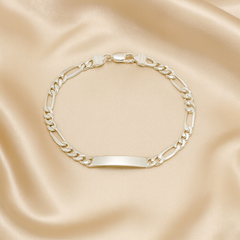 Gold chain bracelet on a satin surface