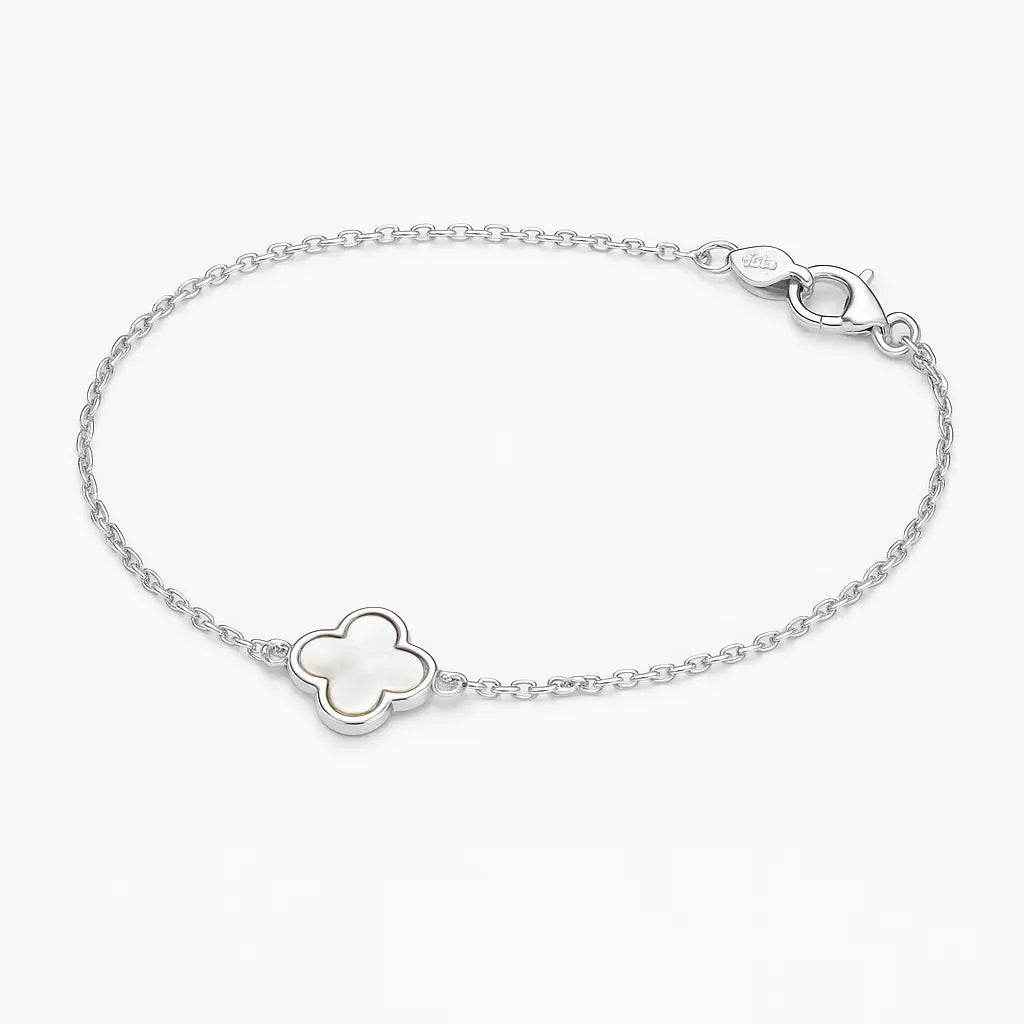 Silver bracelet with a clover-shaped charm on a white background