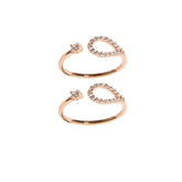 Rose gold open heart-shaped ring with small diamonds on a white background