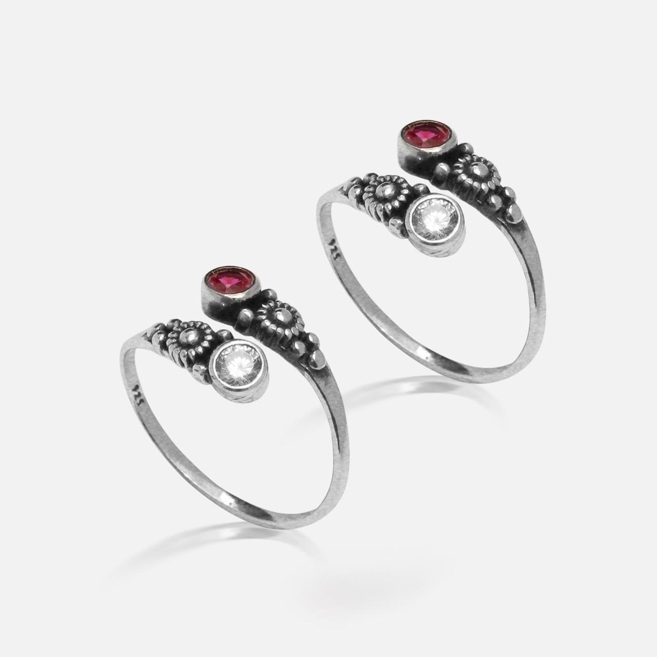 Two silver rings with gemstones on a white background