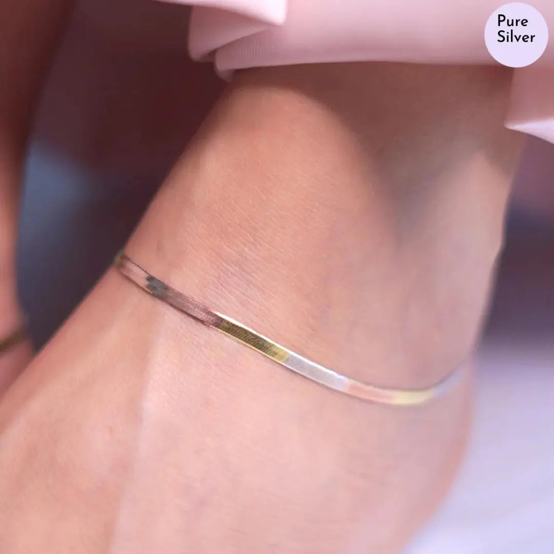 Silver anklet on a person's ankle with 'Pure Silver' text in the corner.
