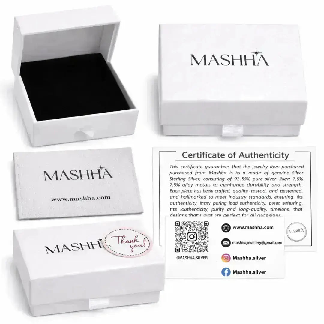 Mashha jewelry packaging with branded box, card, and certificate of authenticity on a white background.