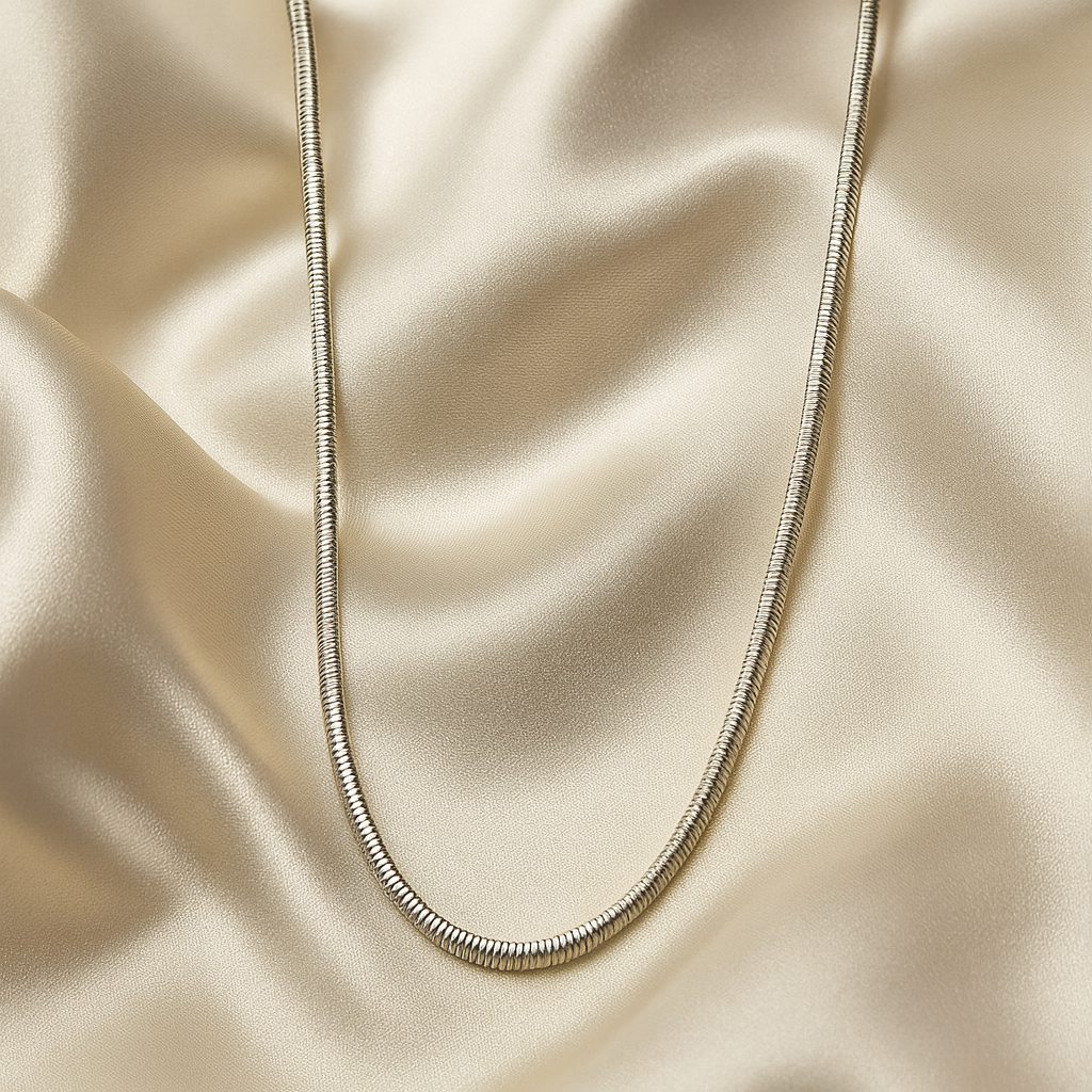 Silver necklace on a beige fabric background