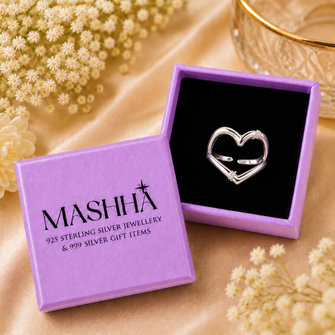 Silver heart-shaped ring in a purple MASHHA jewelry box with flowers around.