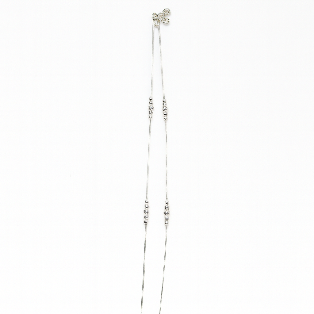 Silver beaded necklace on a white background