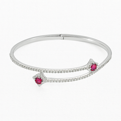 Silver bracelet with red gemstones on a white background