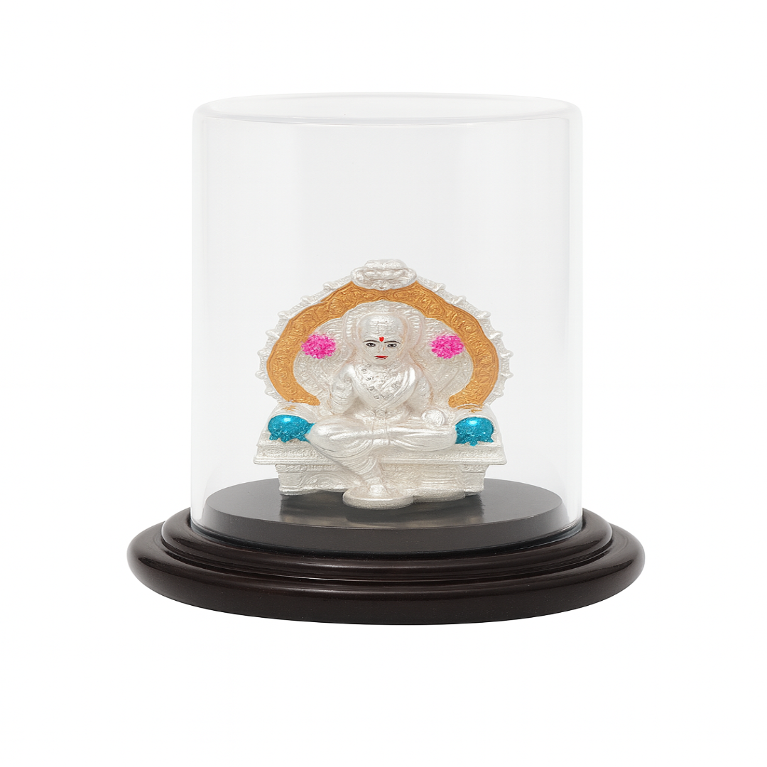 Statue of a deity in a glass dome on a white background