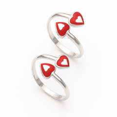 Silver rings with red heart-shaped stones on a white background