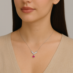 Necklace with a red gemstone pendant worn by a model against a neutral background