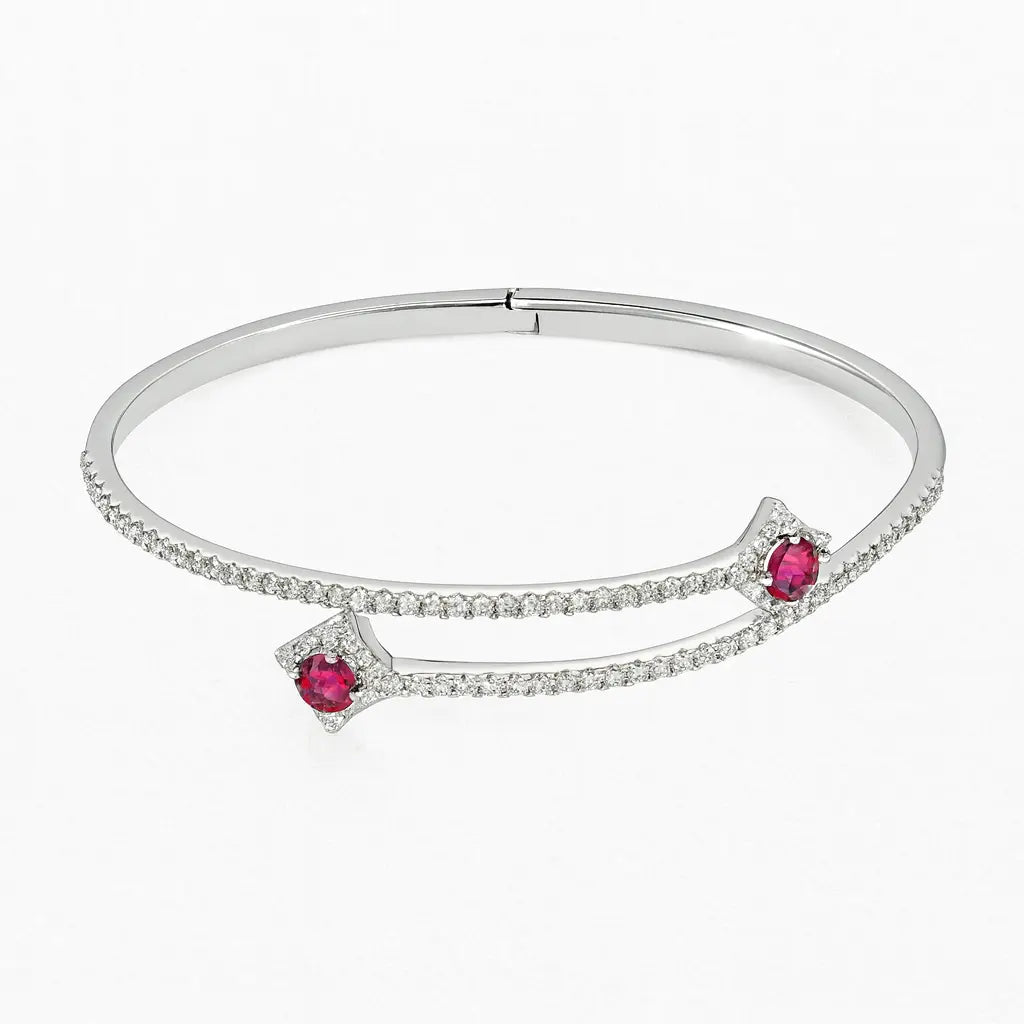 Silver bracelet with red gemstones on a white background