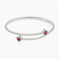 Silver bracelet with red gemstones on a white background