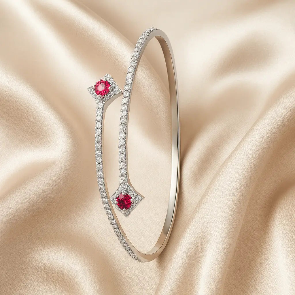 Silver bracelet with red gemstones on a beige satin background