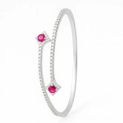 Silver bracelet with pink gemstones on a white background