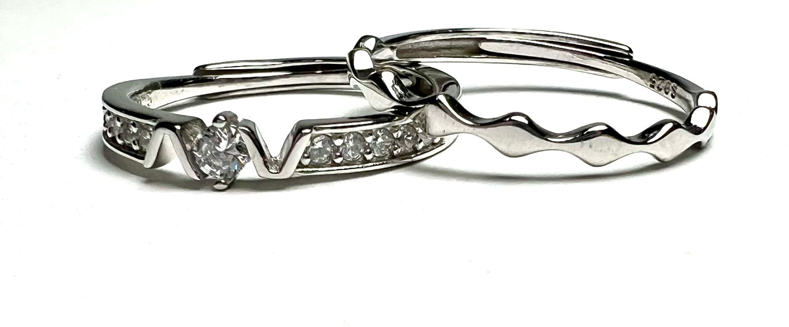 Silver ring with embedded diamonds on a white background